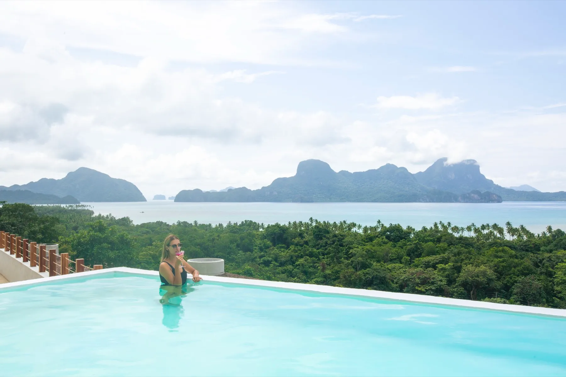 Infinity pool overlooking the bay and limestone islands at Atalaya Resort, El Nido