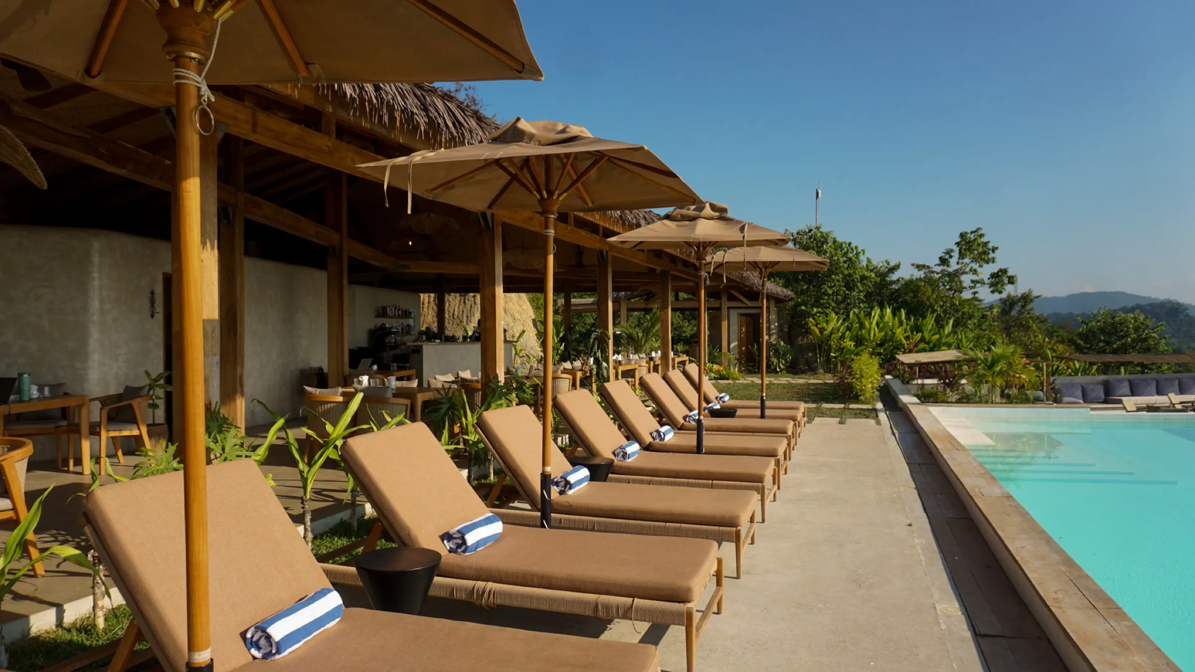 Loungers and parasols along the infinity pool at Atalaya Resort