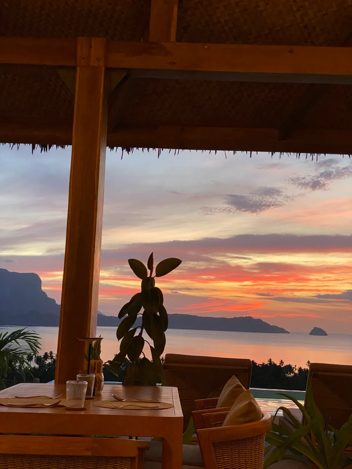 Sunset over the Bacuit archipelago from Atalaya Resort's dining pavilion, El Nido